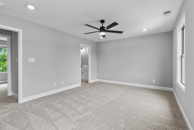 carpeted spare room with ceiling fan