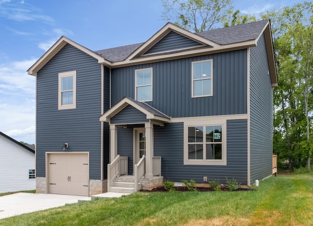 view of front of property featuring a garage and a front lawn