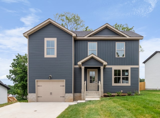 view of front of house featuring a front yard and a garage