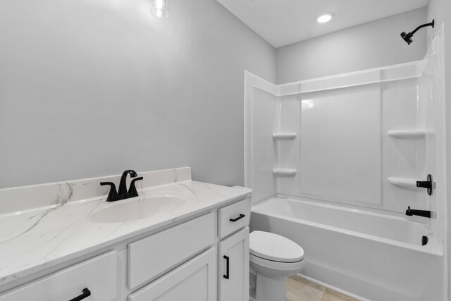 full bathroom featuring toilet, vanity, tile patterned floors, and shower / washtub combination