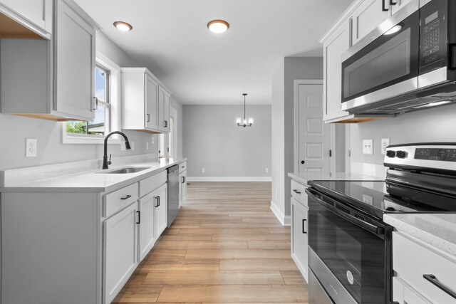 kitchen featuring light hardwood / wood-style floors, white cabinetry, sink, and appliances with stainless steel finishes