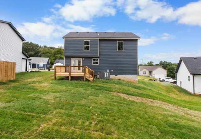 back of house featuring a deck, a yard, and central AC