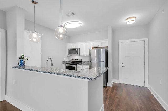 kitchen with kitchen peninsula, white cabinetry, pendant lighting, and stainless steel appliances