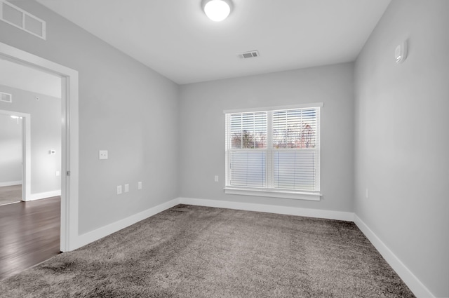 empty room featuring dark colored carpet