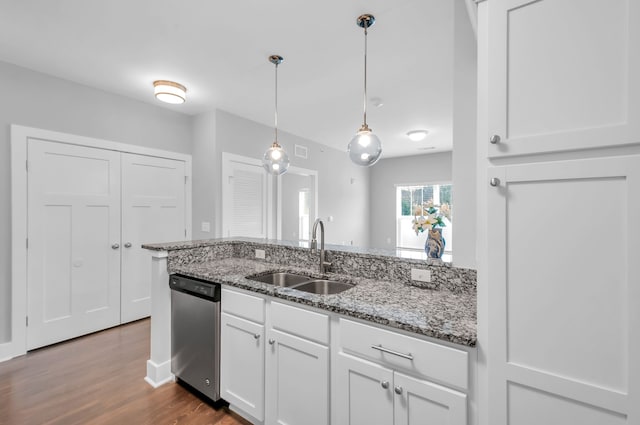 kitchen with dishwasher, hardwood / wood-style floors, white cabinetry, and sink