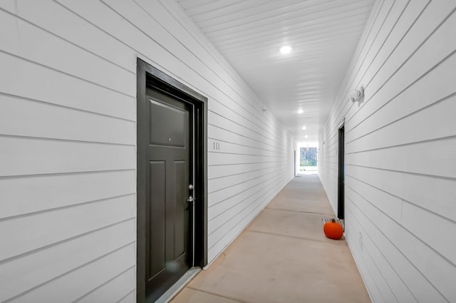 hall featuring wood walls