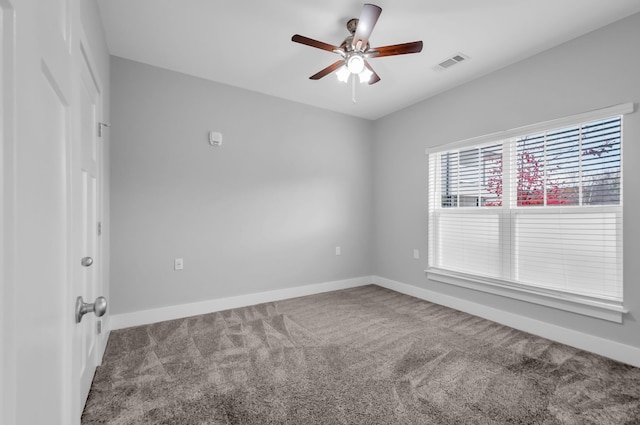 carpeted spare room with ceiling fan