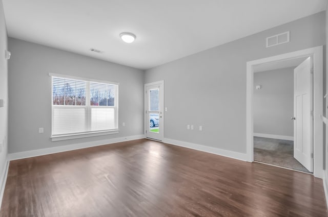 empty room with dark wood-type flooring