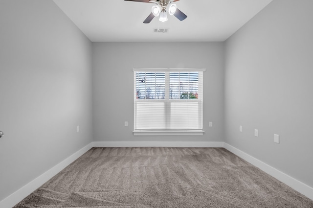 carpeted spare room with ceiling fan