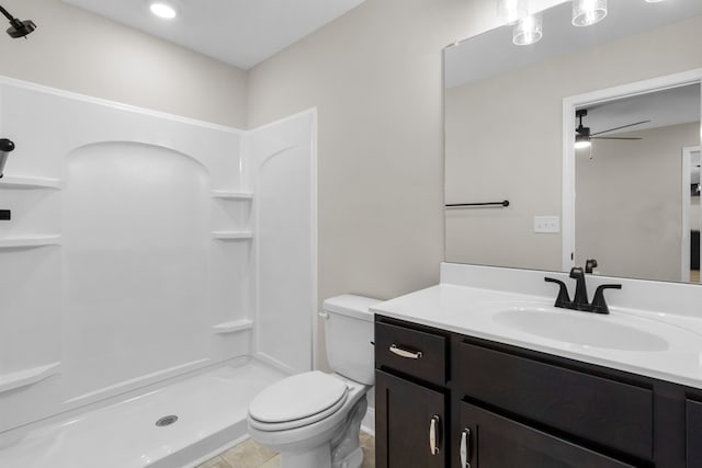 bathroom with vanity, ceiling fan, a shower, tile patterned flooring, and toilet