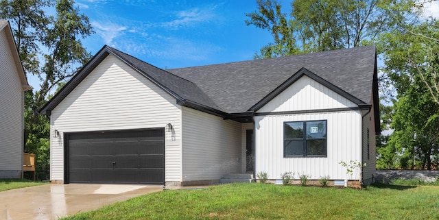 view of front of home featuring a garage and a front lawn