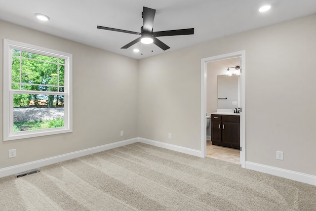 carpeted empty room featuring ceiling fan