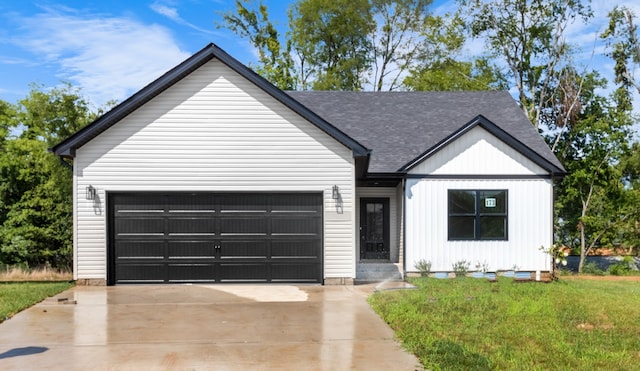 view of front of property with a garage and a front lawn