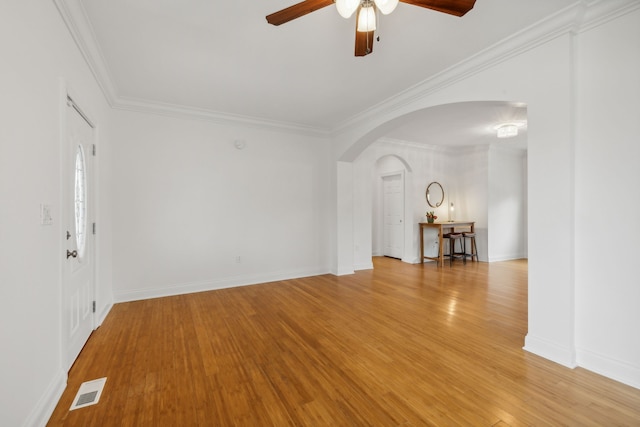 unfurnished room featuring crown molding, ceiling fan, and light wood-type flooring