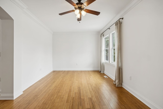 empty room featuring ceiling fan, light hardwood / wood-style floors, and ornamental molding