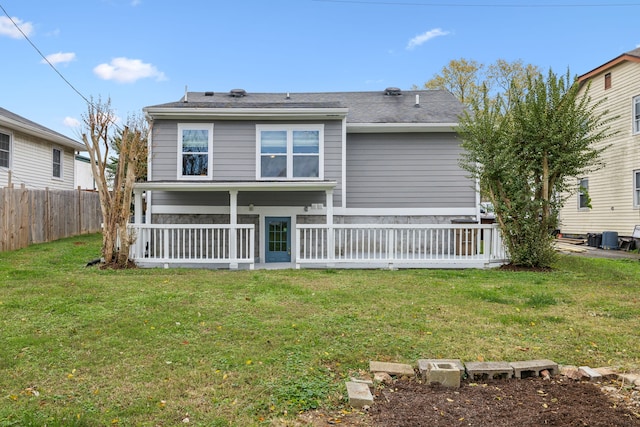 rear view of house featuring a lawn