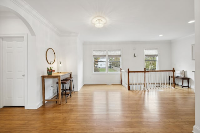 entrance foyer with light hardwood / wood-style flooring and ornamental molding