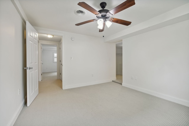 unfurnished bedroom with ceiling fan, light colored carpet, and a closet