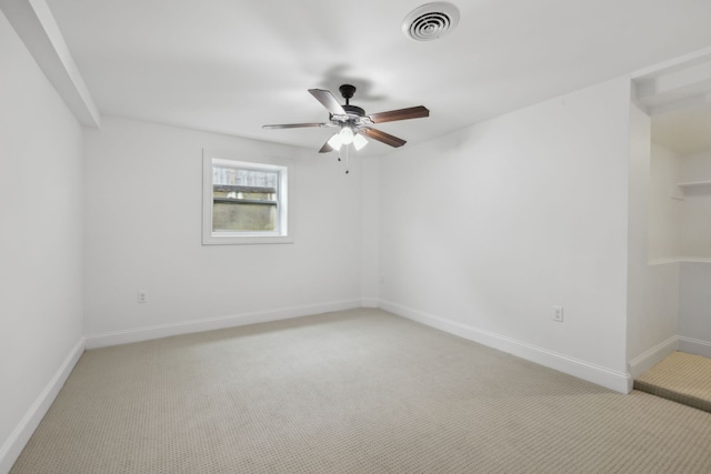 carpeted spare room with ceiling fan