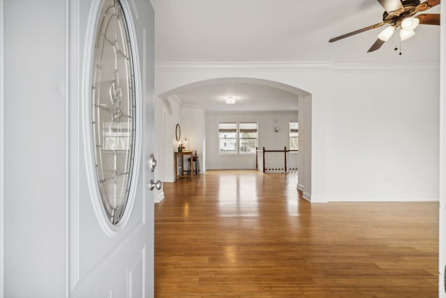 hallway featuring ornamental molding and light hardwood / wood-style flooring