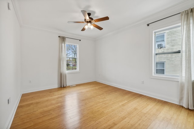 empty room featuring light hardwood / wood-style flooring, ceiling fan, and crown molding