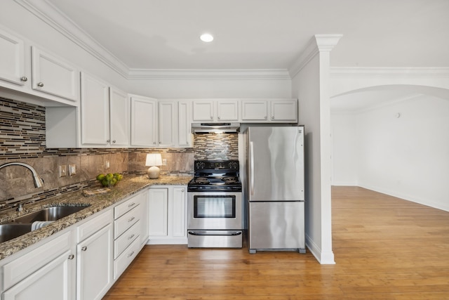 kitchen with white cabinets, light hardwood / wood-style floors, and stainless steel appliances