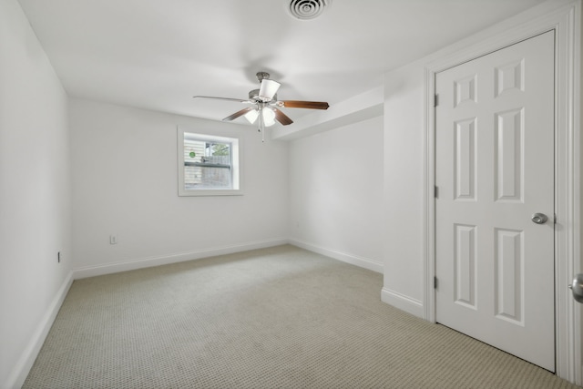 carpeted spare room with ceiling fan