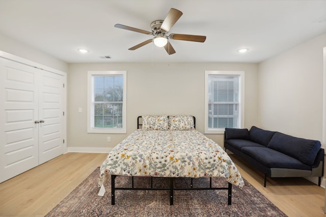 bedroom featuring ceiling fan, hardwood / wood-style flooring, and a closet