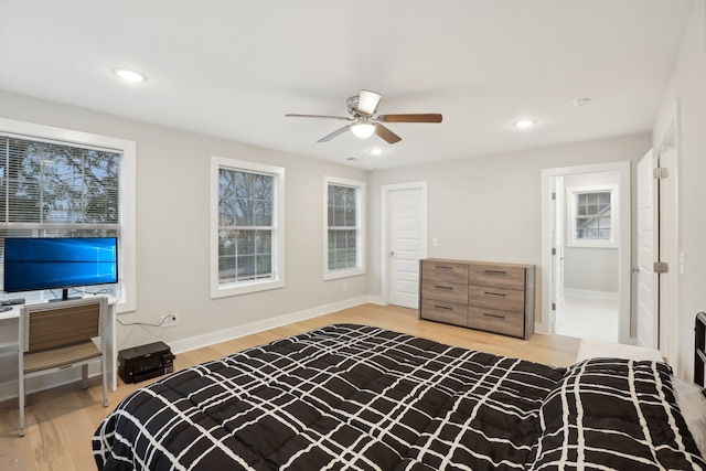 bedroom with ceiling fan and light hardwood / wood-style floors