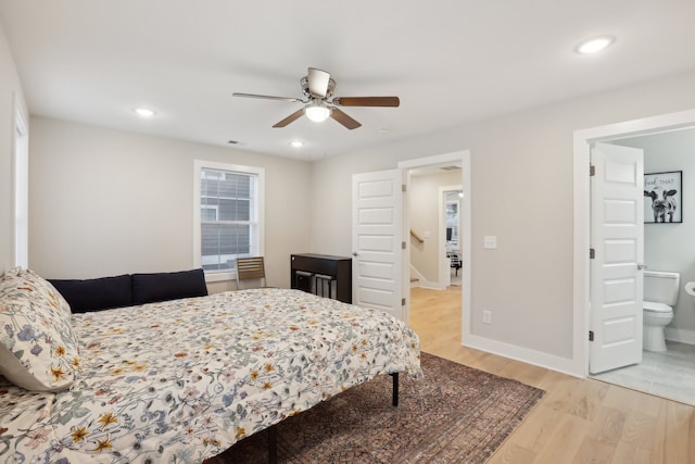 bedroom with ceiling fan, connected bathroom, and wood-type flooring