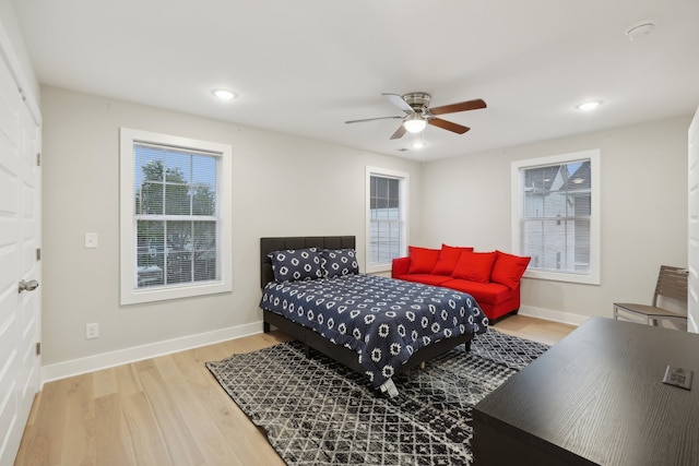 bedroom featuring light hardwood / wood-style floors and ceiling fan