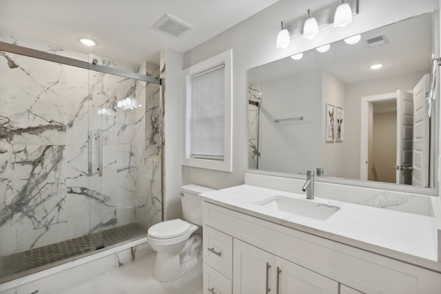 bathroom with vanity, toilet, and an enclosed shower