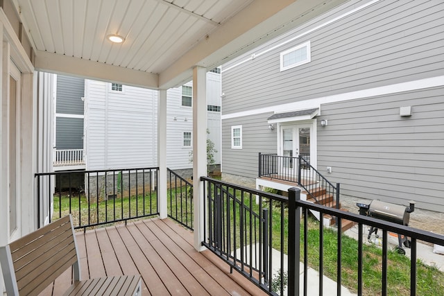 deck featuring a porch and a grill