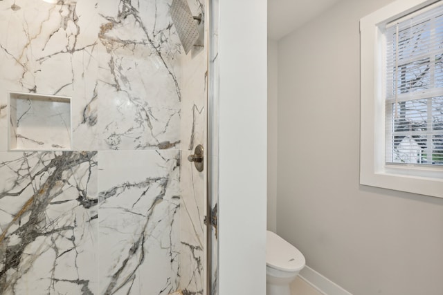 bathroom featuring toilet and walk in shower