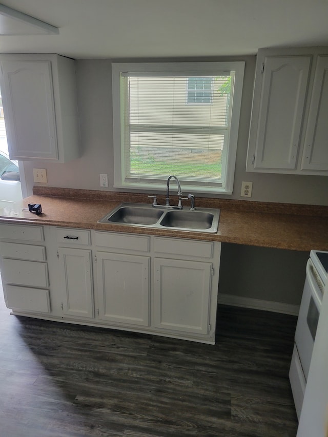 kitchen featuring dark hardwood / wood-style flooring, white cabinetry, sink, and electric stove