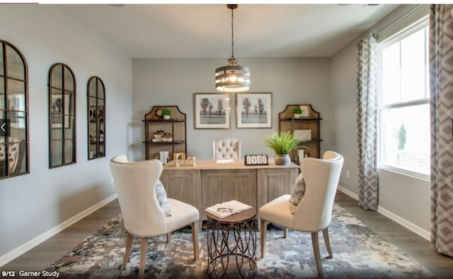 dining room featuring a notable chandelier and dark wood-type flooring