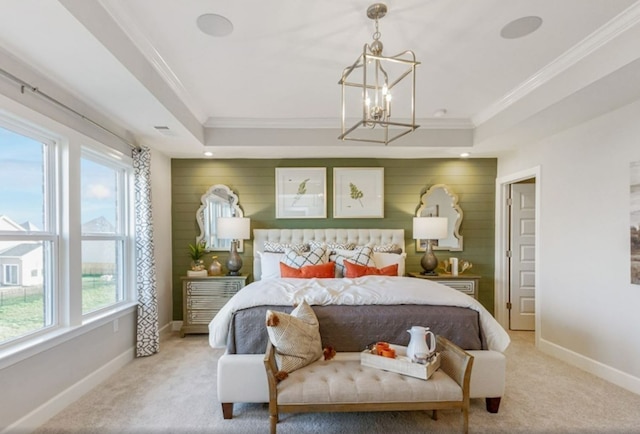 carpeted bedroom with an inviting chandelier, a raised ceiling, ornamental molding, and multiple windows