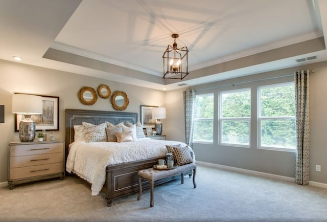 carpeted bedroom with a raised ceiling, ornamental molding, and a notable chandelier