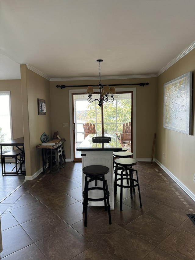 dining area with a chandelier and crown molding