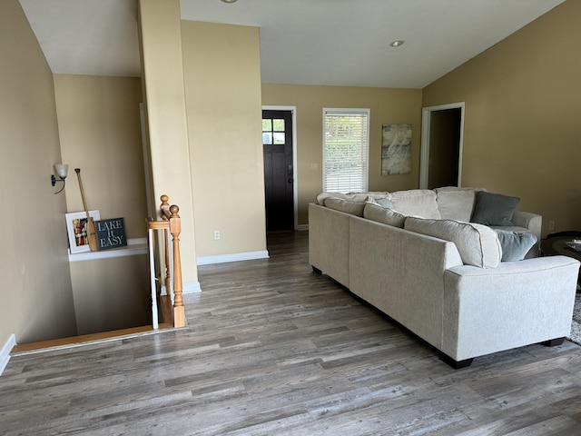 living room featuring hardwood / wood-style floors and vaulted ceiling