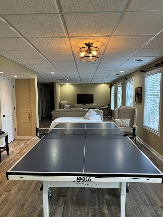 rec room with hardwood / wood-style floors and a paneled ceiling