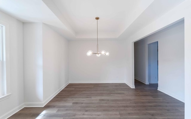 7938 Pine St, Fairview, TN 37062 - unfurnished dining area with a tray ceiling, a chandelier, wood finished floors, and baseboards