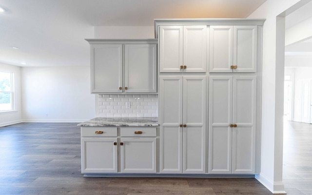 7938 Pine St, Fairview, TN 37062 - kitchen featuring baseboards, dark wood-type flooring, decorative backsplash, light stone countertops, and recessed lighting