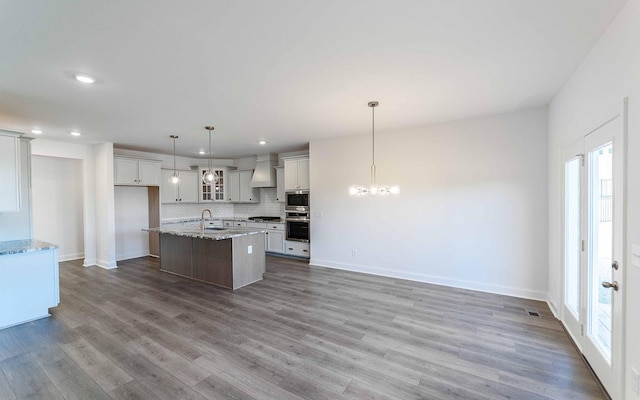 7938 Pine St, Fairview, TN 37062 - kitchen with a sink, custom range hood, healthy amount of natural light, decorative backsplash, and recessed lighting