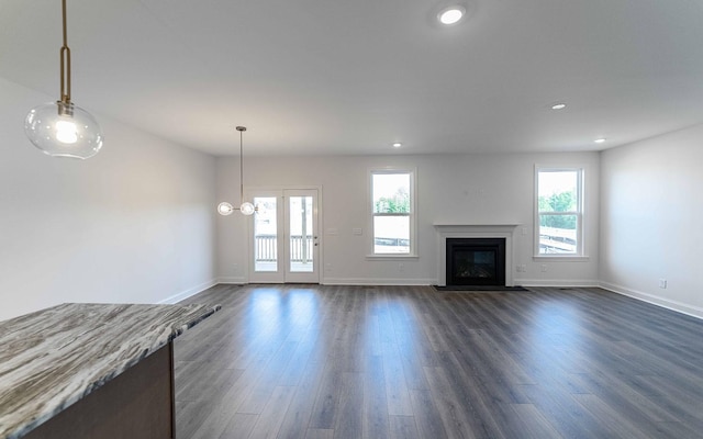 7938 Pine St, Fairview, TN 37062 - unfurnished living room with baseboards, dark wood-type flooring, a glass covered fireplace, and recessed lighting