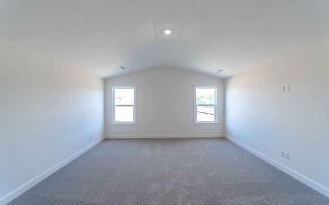 7938 Pine St, Fairview, TN 37062 - unfurnished room with vaulted ceiling, healthy amount of natural light, baseboards, and light carpet