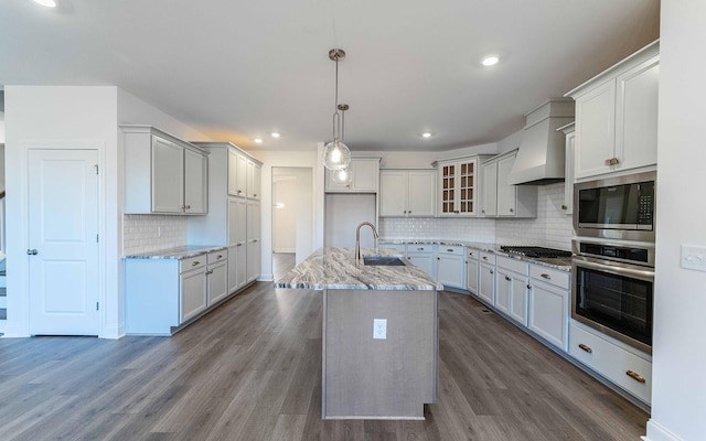 7938 Pine St, Fairview, TN 37062 - kitchen featuring stainless steel appliances, a sink, custom exhaust hood, backsplash, and light stone counters