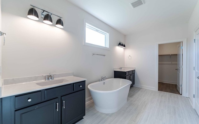 7938 Pine St, Fairview, TN 37062 - full bathroom featuring vanity, a soaking tub, a spacious closet, and baseboards