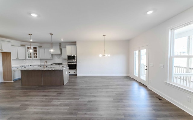 7938 Pine St, Fairview, TN 37062 - kitchen with stainless steel appliances, a sink, glass insert cabinets, a chandelier, and custom range hood