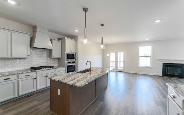 7938 Pine St, Fairview, TN 37062 - kitchen with custom range hood, stainless steel appliances, a sink, dark wood finished floors, and tasteful backsplash